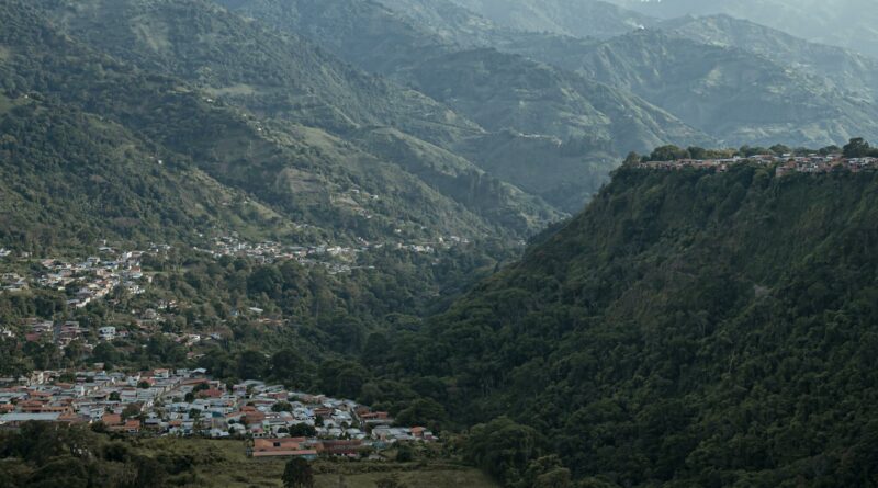 A captivating aerial view of the mountainous landscape in Mérida, Venezuela, showcasing lush greenery and a picturesque town.
