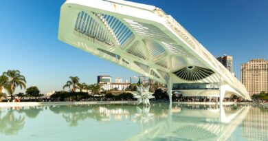 Explore the modern, futuristic design of Museu do Amanhã in Rio de Janeiro, reflecting on calm waters.