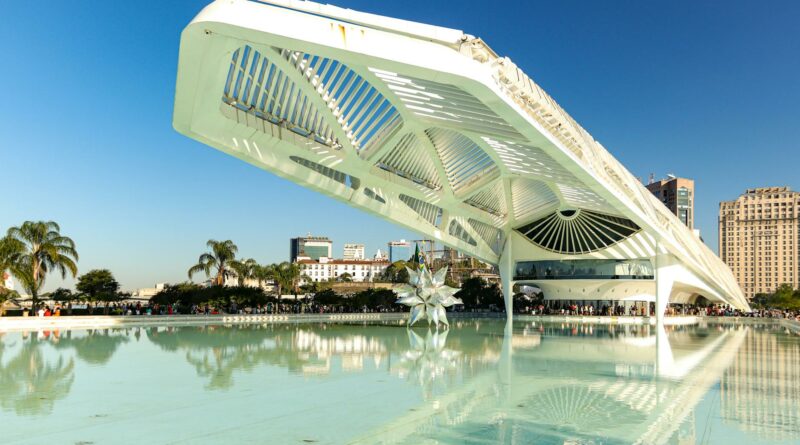 Explore the modern, futuristic design of Museu do Amanhã in Rio de Janeiro, reflecting on calm waters.