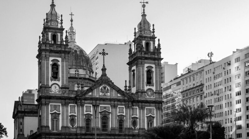Black and white photo of a historic cathedral in Rio de Janeiro, Brazil, surrounded by city buildings.