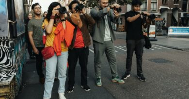 A group of diverse photographers capturing urban scenes on a bustling city street.