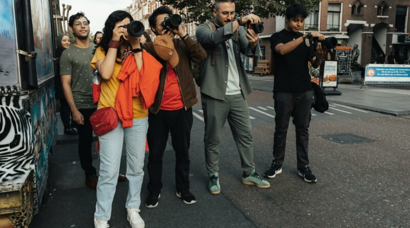 A group of diverse photographers capturing urban scenes on a bustling city street.
