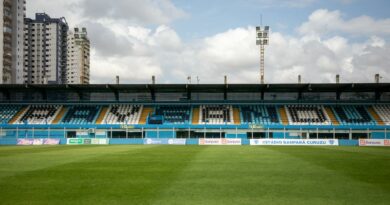 Empty Estádio Banpará Curuzu in Belém, Brazil with green grass and clear sky.