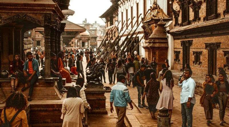 Vibrant street scene in Kathmandu, Nepal showcasing historical architecture and a diverse crowd.
