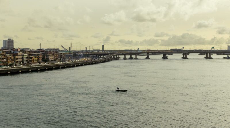 A tranquil scene of Carter Bridge spanning over water in Lagos, capturing urban and waterside charm.