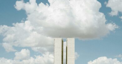 View of the National Congress in Brasília with impressive cloud formations in the sky.