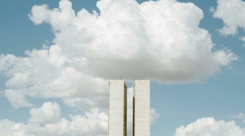 View of the National Congress in Brasília with impressive cloud formations in the sky.