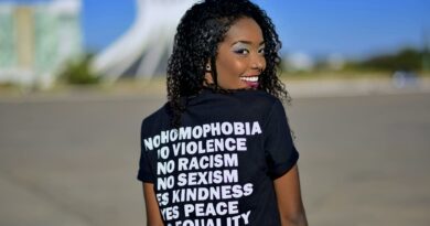 Portrait of a woman in DF, Brazil, promoting equality with positive messages on her shirt.