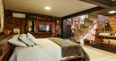 Stylish bedroom in Santa Teresa, Brasil with exposed brick and modern design.