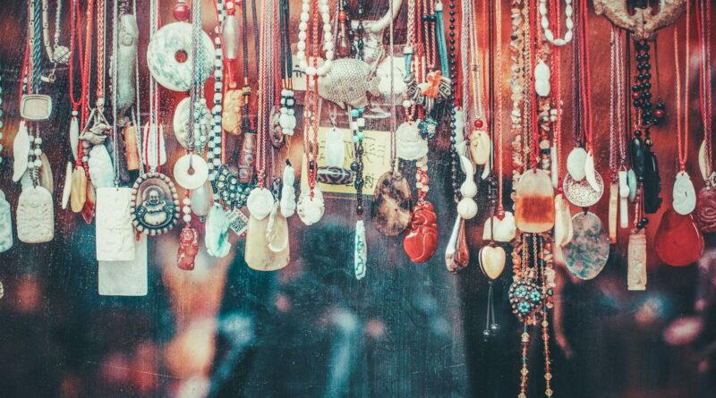 Vibrant collection of various pendants hanging in a Beijing market. A display of cultural and artistic jewelry.