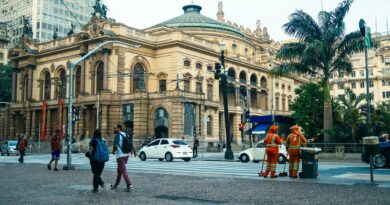 Street view of São Paulo Municipal Theatre with pedestrians and workers in Sao Paulo.