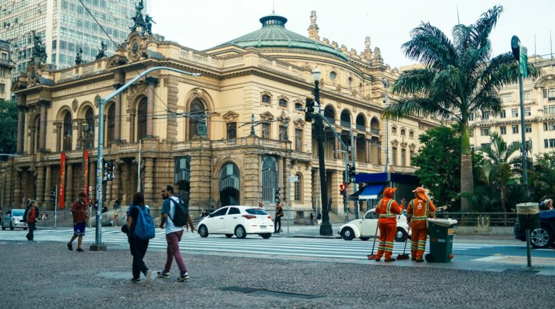 Street view of São Paulo Municipal Theatre with pedestrians and workers in Sao Paulo.
