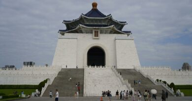 Front view of the iconic Chiang Kai-shek Memorial Hall in Taipei, Taiwan, on a cloudy day.