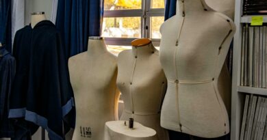 A glimpse into a fashion design studio featuring dress forms against a window backdrop.