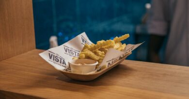 Delicious crispy french fries served with dip on a wooden surface at a São Paulo restaurant.