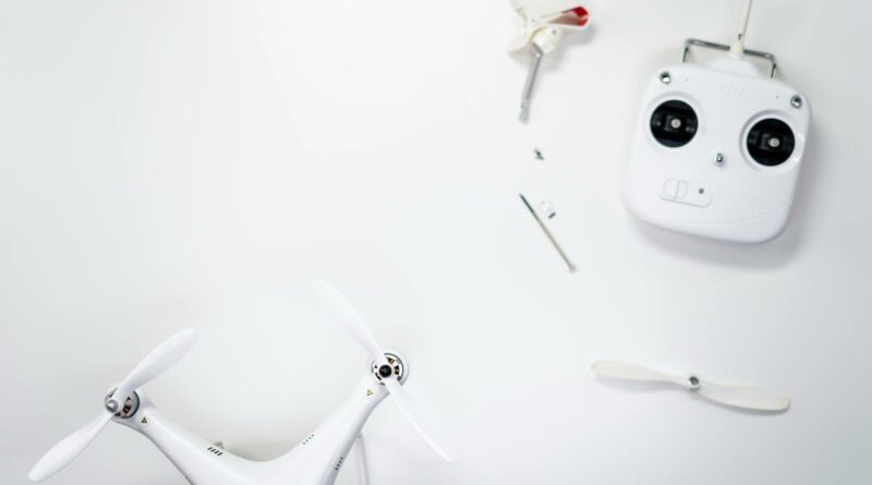 A flat lay of a drone kit including a controller and spare propellers on a white background.