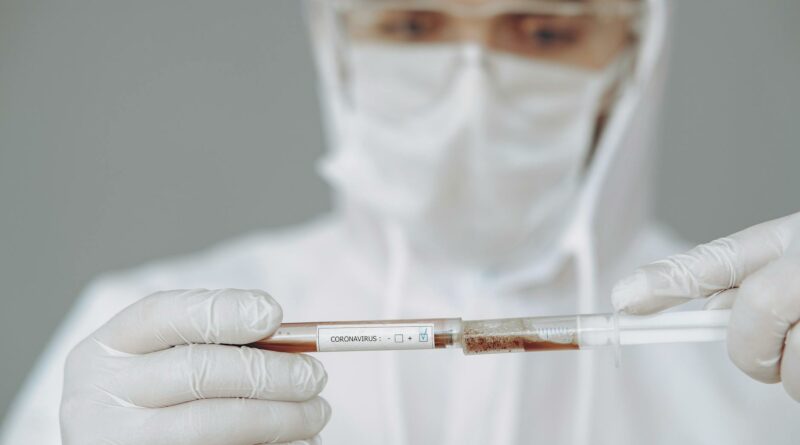 Lab scientist analyzing COVID-19 sample with protective gear. Concept of modern healthcare and virus research.