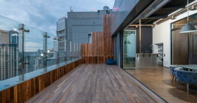 Empty spacious terrace with wooden floor and walls placed in modern apartment in cloudy day