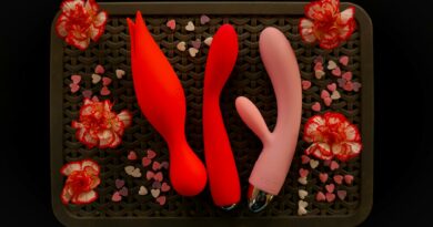 Top view of vibrantly arranged sexual wellness products with flowers.