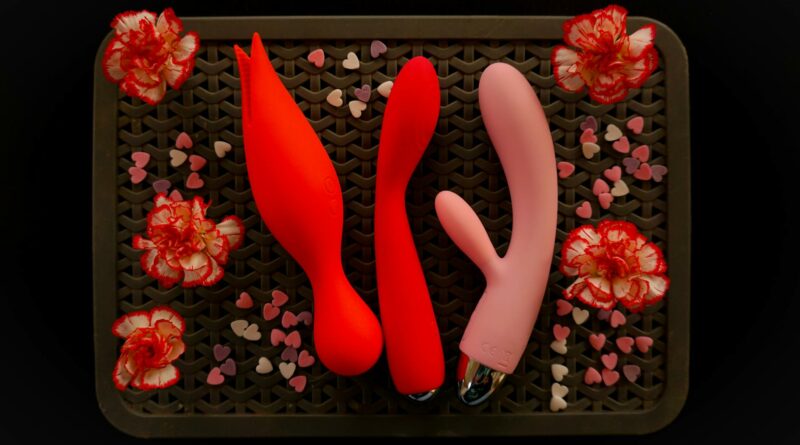 Top view of vibrantly arranged sexual wellness products with flowers.