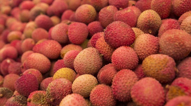 Vibrant close-up of a fresh pile of lychees showing texture and color in natural lighting.