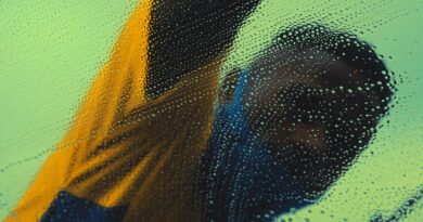 Anonymous man in São Paulo washing glass with soap and bubbles, creating a blurred effect.