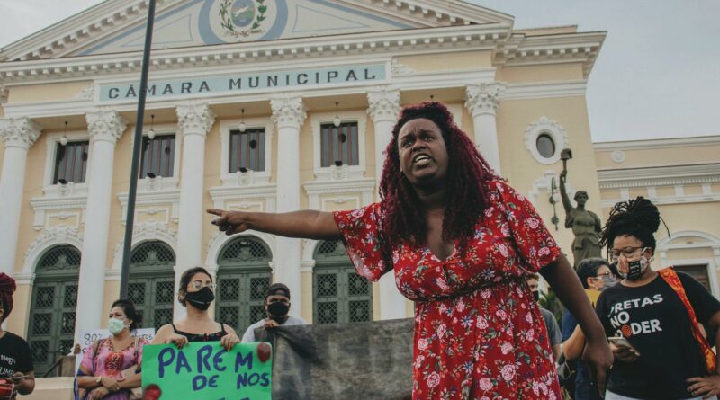 Protesters gather passionately outside the Câmara Municipal in Rio de Janeiro for social justice.