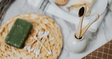Discover eco-friendly bathroom essentials including wooden toothbrushes and bamboo cotton swabs for a zero waste lifestyle.