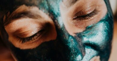 Serene close-up of closed eyes during a colorful facial mask treatment, highlighting relaxation and skincare.
