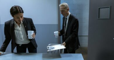 Two professionals in a secure office setting discussing confidential documents over coffee.