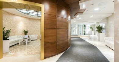 A spacious and luxurious hotel lobby with contemporary decor and natural lighting.