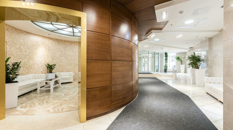 A spacious and luxurious hotel lobby with contemporary decor and natural lighting.