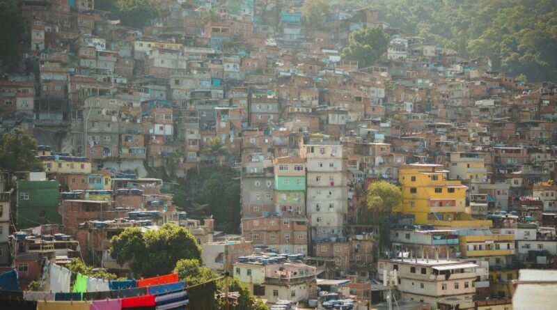 Vivid hillside houses in a densely packed Rio de Janeiro neighborhood, illustrating vibrant urban life.