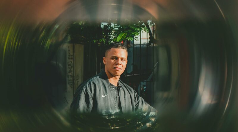 Artistic portrait of a man outdoors in São Paulo, Brasil with a creative lens effect capturing natural light.