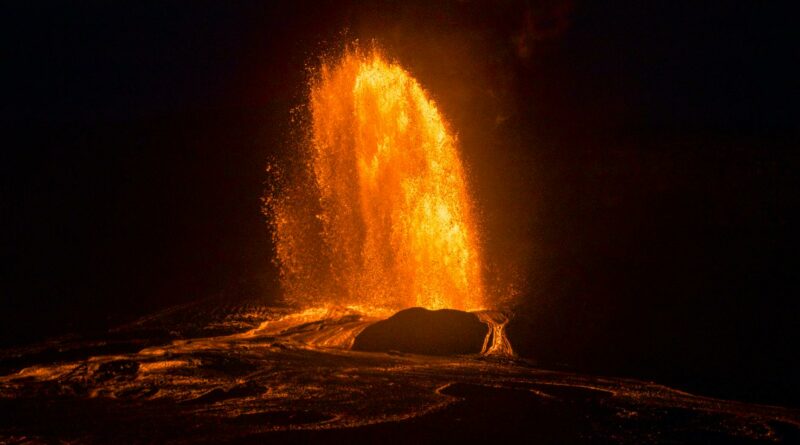 Stunning night capture of a fiery volcanic eruption in Hawaii with glowing lava.