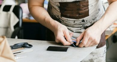 Close-up of an artisan crafting with precision in a workshop, emphasizing craftsmanship.