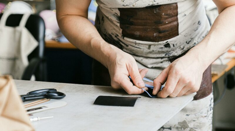 Close-up of an artisan crafting with precision in a workshop, emphasizing craftsmanship.