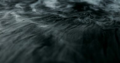 Enigmatic swirling smoke over a dark surface creating a mysterious ambiance.