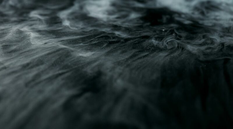 Enigmatic swirling smoke over a dark surface creating a mysterious ambiance.